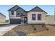 Charming two-story home with a gray garage and rock landscaping in the front yard at 39836 Floyd St, Elizabeth, CO 80107