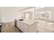Kitchen island featuring a sink and dishwasher, complemented by an open-concept living area at 39836 Floyd St, Elizabeth, CO 80107