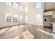 Bright living room with large windows, hardwood floors, and stainless steel refrigerator at 39836 Floyd St, Elizabeth, CO 80107