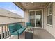 Relaxing covered back porch with cushioned seating, a gas fire pit, and string lights at 17614 Drake St, Broomfield, CO 80023