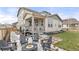 Spacious backyard with firepit area, covered patio, and well-maintained lawn at 17614 Drake St, Broomfield, CO 80023