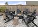 Backyard with a gravel firepit area, black Adirondack chairs, and a firepit at 17614 Drake St, Broomfield, CO 80023