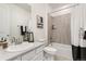 Bright bathroom featuring a bathtub, shower with tile surround, white vanity and decor at 17614 Drake St, Broomfield, CO 80023