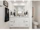 Elegant bathroom featuring double sinks, and a large mirror at 17614 Drake St, Broomfield, CO 80023