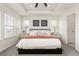 Bright bedroom with large windows, tray ceiling and charming decor, creating a relaxing ambiance at 17614 Drake St, Broomfield, CO 80023