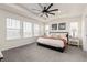 Spacious bedroom with large windows, ceiling fan, tray ceiling and cozy decor at 17614 Drake St, Broomfield, CO 80023