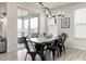 Cozy dining room with modern chandelier and black metal chairs next to sliding door to the outside at 17614 Drake St, Broomfield, CO 80023