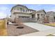 Attractive two-story house boasts a manicured yard with a well-maintained lawn, and a driveway leading to a two-car garage at 17614 Drake St, Broomfield, CO 80023