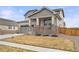 Charming two-story house features a front yard, a side driveway leading to a two-car garage, and a welcoming front porch at 17614 Drake St, Broomfield, CO 80023
