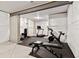 Home gym with rubber flooring, free weights, bench, treadmill, and exercise bike at 17614 Drake St, Broomfield, CO 80023