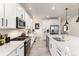 Bright kitchen featuring white cabinets, stainless steel appliances, and a large island with quartz countertops at 17614 Drake St, Broomfield, CO 80023