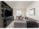 Cozy living room with a comfortable couch, custom built-in entertainment center, and ample natural light at 17614 Drake St, Broomfield, CO 80023