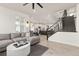Open-concept living room and kitchen area with modern decor and a staircase leading to the upper level at 17614 Drake St, Broomfield, CO 80023