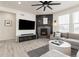 Inviting living room featuring a fireplace, large TV, and comfortable sectional sofa at 17614 Drake St, Broomfield, CO 80023