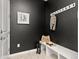 Chic mudroom featuring a white bench, hooks for storage, and stylish decor on a dark wall at 17614 Drake St, Broomfield, CO 80023