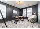 Stylish office with black walls, a wooden desk, natural light, and comfortable seating at 17614 Drake St, Broomfield, CO 80023