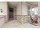 Inviting covered porch with rocking chairs, stone accents, and a view of the neighborhood at 17614 Drake St, Broomfield, CO 80023