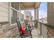 Cozy front porch featuring rocking chairs with red pillows, offering a relaxing outdoor seating area at 17614 Drake St, Broomfield, CO 80023