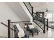 Elegant stairway with dark wood railings and banisters, leading to the home's upper level at 17614 Drake St, Broomfield, CO 80023