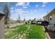 A spacious backyard with a large lawn, wooden deck, and partial privacy fence offers ample outdoor space at 9508 Lou Dr, Northglenn, CO 80260
