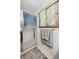 Updated bathroom featuring glass shower door and tiled wall with convenient towel racks at 9508 Lou Dr, Northglenn, CO 80260