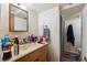 Bathroom area with vanity, sink, mirror, and adjacent shower with curtain at 9508 Lou Dr, Northglenn, CO 80260
