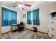 Functional bedroom featuring a ceiling fan, a desk with rolling chair, and laminate wood flooring at 9508 Lou Dr, Northglenn, CO 80260