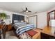 Bedroom with wood floor, ceiling fan, double door closet, and decorative touches at 9508 Lou Dr, Northglenn, CO 80260