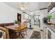 Charming dining area adjacent to the kitchen, featuring a cozy booth and wooden table, perfect for Gathering meals at 9508 Lou Dr, Northglenn, CO 80260