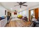 Spacious living room featuring wood look floors, a ceiling fan and comfortable seating at 9508 Lou Dr, Northglenn, CO 80260