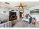 Spacious living room features modern furniture, a large TV with a wooden stand, and soft lighting for a relaxing ambiance at 9508 Lou Dr, Northglenn, CO 80260
