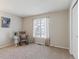 Bright bedroom with carpeting, window, and rocking chair at 8471 Everett Way # A, Arvada, CO 80005