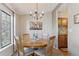 Charming dining area with wood table and chairs, adjacent to kitchen at 8471 Everett Way # A, Arvada, CO 80005