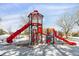 Modern red playground with a tall climbing structure and slides at 8471 Everett Way # A, Arvada, CO 80005