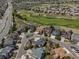 Aerial view of a neighborhood with well-manicured lawns, golf course and tree-lined streets at 22665 E Calhoun Pl, Aurora, CO 80016