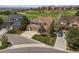 An aerial view of a brown two story home with mature landscaping, three car garage, and close to a golf course at 22665 E Calhoun Pl, Aurora, CO 80016