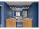 This bathroom showcases a double vanity, and a well-lit mirror, with a blue accent wall at 22665 E Calhoun Pl, Aurora, CO 80016