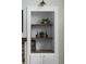 White built-in shelves with decorative items, next to the fireplace, add to the home's interior charm at 22665 E Calhoun Pl, Aurora, CO 80016