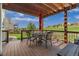 Covered deck with wrought iron table, chairs, and umbrella offers a relaxing outdoor living space at 22665 E Calhoun Pl, Aurora, CO 80016