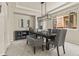 Elegant dining room featuring a modern chandelier, ample seating, and access to the kitchen at 22665 E Calhoun Pl, Aurora, CO 80016