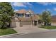 Charming two-story home featuring a three-car garage, stone accents, and a well-manicured lawn at 22665 E Calhoun Pl, Aurora, CO 80016