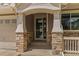 Inviting front entrance with stone pillars and trim, leading to a beautifully designed front door at 22665 E Calhoun Pl, Aurora, CO 80016