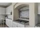 Close up of gas range and modern backsplash with custom spice rack at 22665 E Calhoun Pl, Aurora, CO 80016