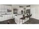 Well-lit kitchen featuring white cabinets, granite countertops, and modern stainless steel appliances at 22665 E Calhoun Pl, Aurora, CO 80016
