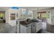 Open-concept kitchen with granite counters flowing into living space, fireplace, and expansive windows at 22665 E Calhoun Pl, Aurora, CO 80016