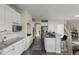Spacious kitchen with white cabinets, granite countertops, stainless steel appliances, and bar seating at 22665 E Calhoun Pl, Aurora, CO 80016