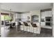 Open-concept kitchen with white cabinets, granite countertops, and a breakfast bar with bar stool seating at 22665 E Calhoun Pl, Aurora, CO 80016