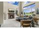 Bright living room with a fireplace, large windows, and comfortable seating arrangement at 22665 E Calhoun Pl, Aurora, CO 80016