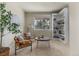 Cozy reading room with built-in bookshelves, comfortable chairs, and a view of the outdoors at 22665 E Calhoun Pl, Aurora, CO 80016