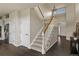Bright staircase features wood railing, carpeted steps and leads to the upper level at 22665 E Calhoun Pl, Aurora, CO 80016